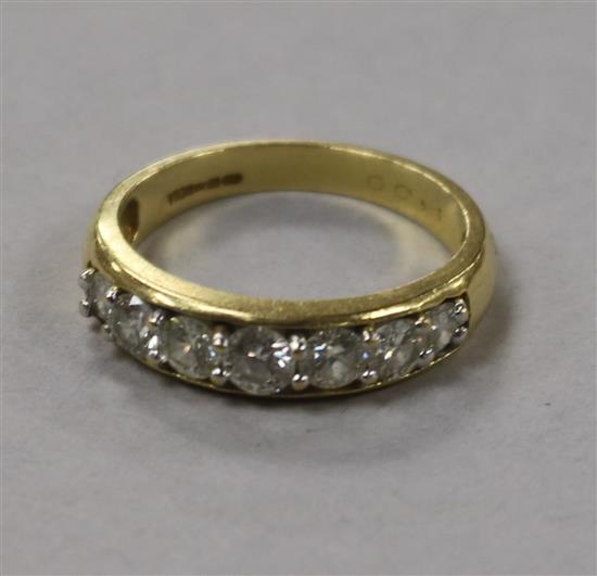 An 18ct gold and graduated seven stone diamond half hoop ring, size P.